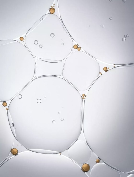 Abstract rendering of translucent bubbles with gold particles